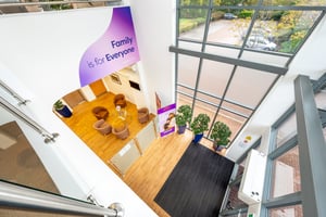 Birds-eye view of the Care Fertility Cheshire atrium at Daresbury Park, Warrington, looking from the upstairs waiting area down into the bright, welcoming foyer.