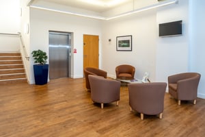 Comfortable seating area with lift access at Care Fertility Cheshire, Daresbury Park, Warrington — a calm, welcoming clinic space.