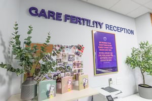 Wall signage at Care Fertility Nottingham’s first-floor reception, displayed alongside cards and photos of babies.