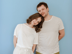 A heterosexual couple with the woman leaning on her partner.