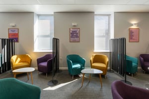 Seating area in the Care Fertility Leeds clinic featuring modern chairs and small tables for patients and visitors.