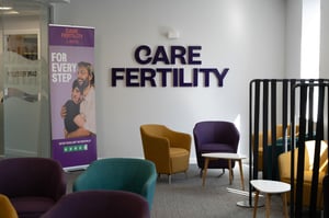 Care Fertility Leeds branded reception seating area with modern décor and comfortable chairs.