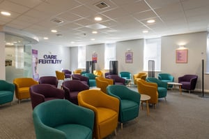 Spacious Care Fertility Leeds reception waiting room with multiple colourful chairs and open-plan seating.