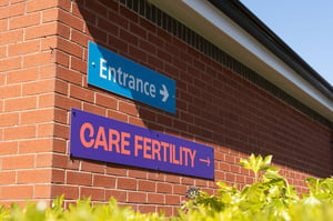 Exterior wall signage directing visitors to the Care Fertility Leeds clinic entrance.