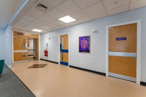 Bright clinic corridor at Care Fertility Leeds with consultation room entrances and accessible layout.