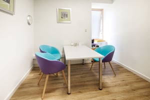 A consultation room at Care Fertility Bath, with two comfortable chairs for patients.