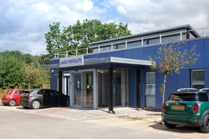The exterior of the Care Fertility Bath clinic, with patient parking in front.