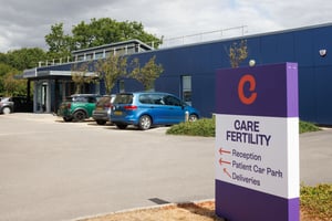 Signage outside Care Fertility Bath, showing directions to reception and patient parking.