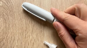 Hand holding a weight loss injection pen - Mounjaro, Ozempic, Wegovy