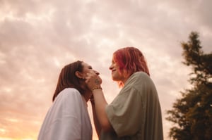 Young same-sex female couple with sky in background
