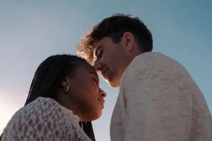 A couple facing each other with their eyes closed